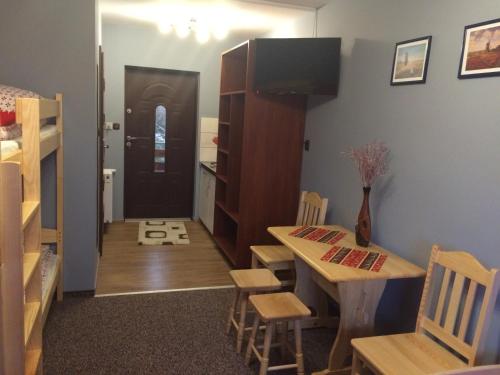a room with a table and chairs and a door at Mączne Skały in Biały Kościół