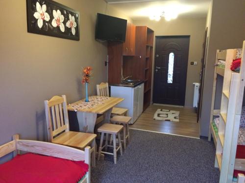 a dorm room with a table and a dining room at Mączne Skały in Biały Kościół
