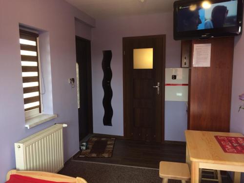 a room with a door and a television on the wall at Mączne Skały in Biały Kościół