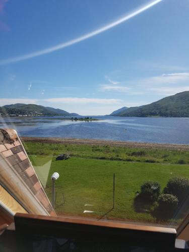 a view of a lake from the roof of a house at Fort William loft on shore front with amazing views in Caol