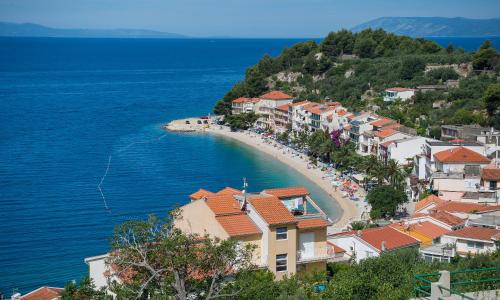 a town on a hill with a beach and the ocean at Villa with Sea View in Podgora
