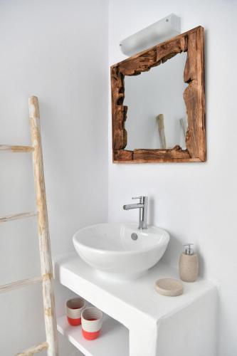 a bathroom with a white sink and a mirror at Ciel Villas Paros in Pounda