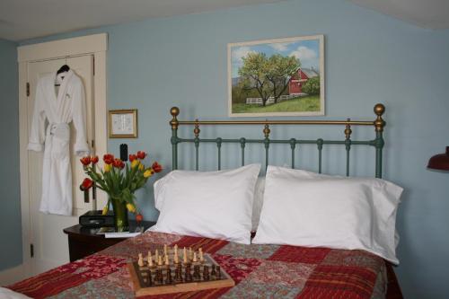 a bedroom with a bed with a chess board on it at Sugar Hill Inn in Sugar Hill