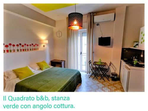 a bedroom with a bed and a television and a table at Il Quadrato Bed and Breakfast in Marina di Schiavonea