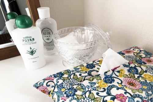 a bathroom counter with a towel and a bottle of soap at TerraceRin YN33 in Tomigusuku