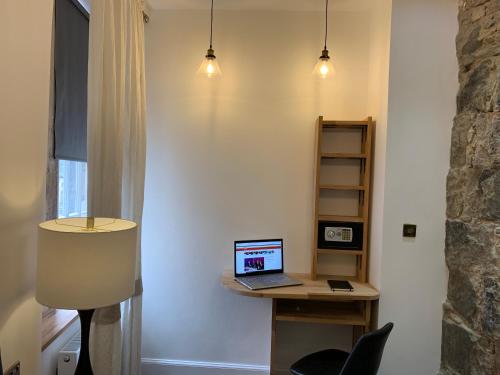 a laptop computer sitting on a desk in a room at Royal Mile Suites by the Castle in Edinburgh