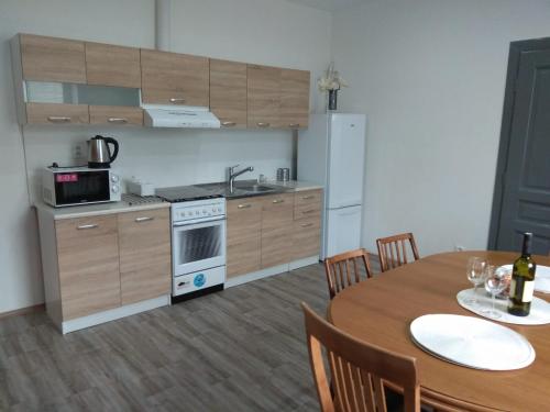 a kitchen with a table and a kitchen with a stove at Apartmány U splavu in Veselí nad Moravou