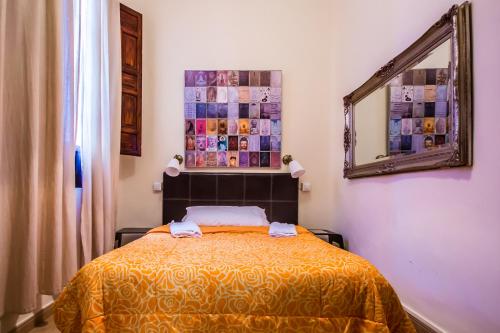 a bedroom with a bed and a painting on the wall at Nuevo Suizo in Seville