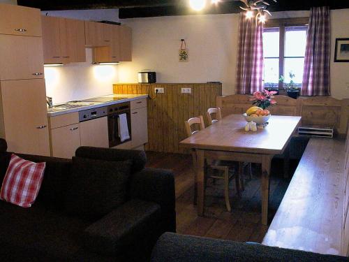 a kitchen with a table with a bowl of fruit on it at 2 - 6 Person Holiday Apartment in Pichl