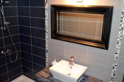 a bathroom with a sink and a mirror at Aiolos House in Skiathos Town