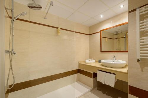 a bathroom with a sink and a shower at Hotel Vibra s'Estanyol in San Antonio Bay