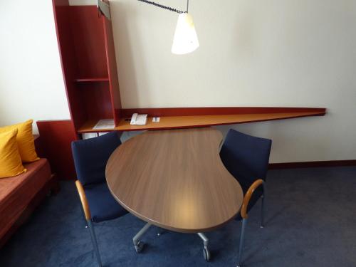 a table and two chairs in a room at Novotel Suites Marseille Centre Euromed in Marseille