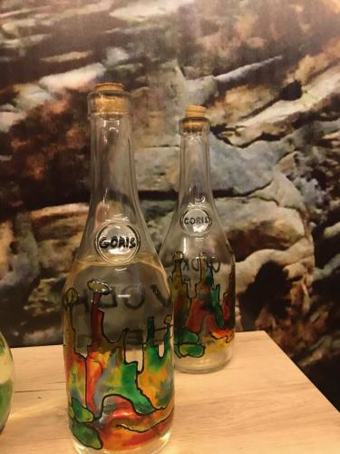two glass bottles sitting on top of a table at Christy Hotel in Goris