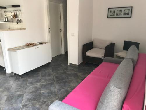 a living room with a couch and a chair at Le Casuzze del Residence Lido Burrone in Favignana