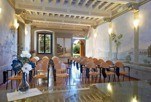 a room with a bunch of chairs in it at Villa La Stella in Florence