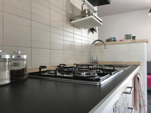 a kitchen counter with a stove and a sink at Le Casuzze del Residence Lido Burrone in Favignana