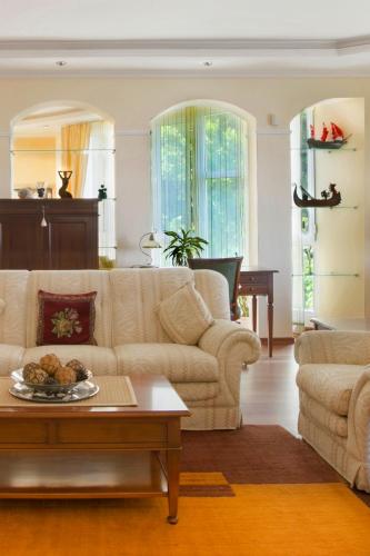 a living room with a couch and a table at Royal Holiday Apartments Sveti Stefan in Sveti Stefan