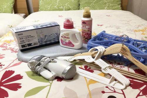 a close up of a bed with a thermometer and cosmetics at TerraceRin YN12 in Tomigusuku