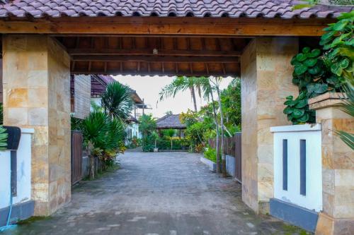 an entrance to a house with a driveway at Friends Beach Hotel in Kuta Lombok