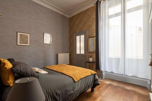 Un pat sau paturi într-o cameră la Le cœur de Reims, la mairie et le Boulingrin