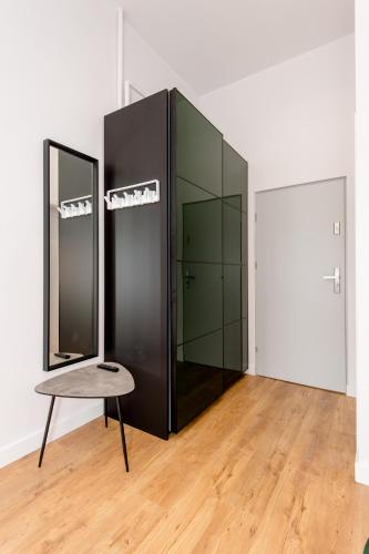 a room with two mirrors and a table in it at Bliss Apartments in Poznań