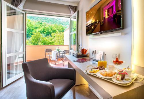 a kitchen with a table with a plate of food on it at Guesia Village Hotel e Spa in Foligno