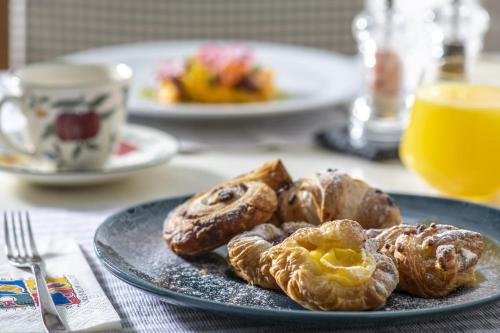 a plate of pastries on top of a table at Erla Villa Boutique Hotel in Eger