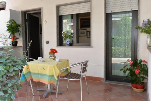 a table with a rainbow table cloth on a patio at Miramare Residence in Pozzuoli