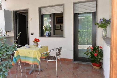 a table with a yellow table cloth on a patio at Miramare Residence in Pozzuoli