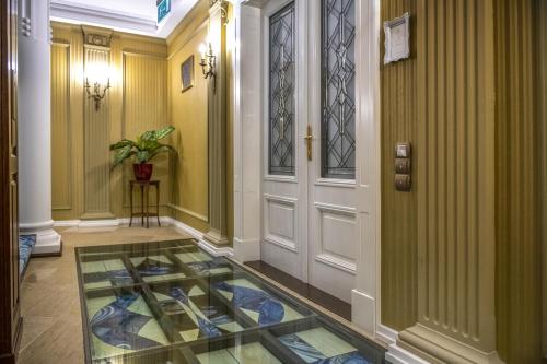 a hallway with a glass floor next to a door at Erla Villa Boutique Hotel in Eger