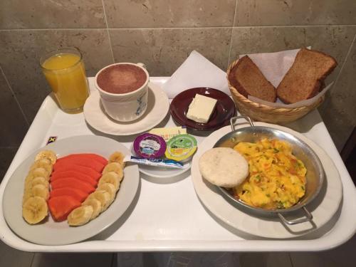 a tray of breakfast food on a table at Posada Portal de la Villa in Villa de Leyva