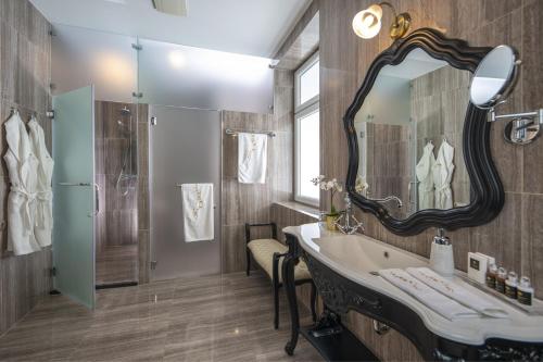 a bathroom with a sink and a mirror at Erla Villa Boutique Hotel in Eger