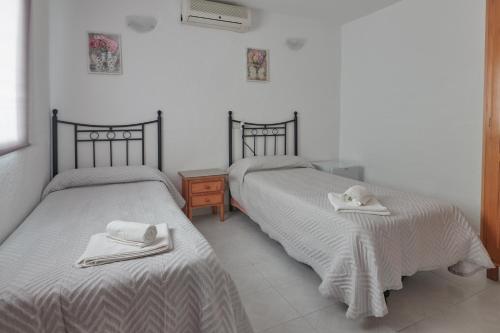 two beds sitting next to each other in a room at Hostal Guerra in Marbella