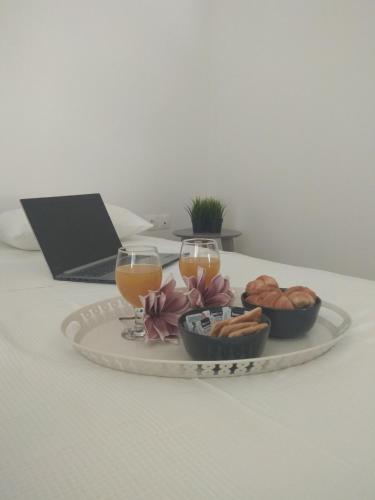 a tray of food and two glasses of orange juice and bread at DREAM & HARMONY in Artemida