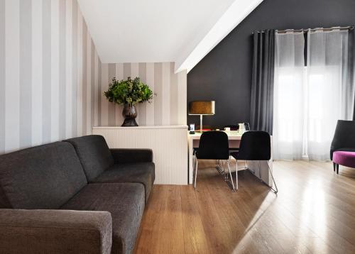 a living room with a couch and a table at Catalonia Reina Victoria in Ronda