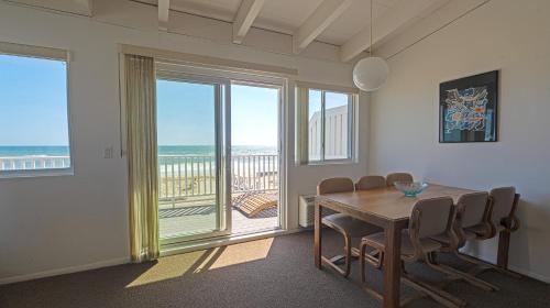 a dining room with a table and a view of the ocean at Sea Crest in Amagansett