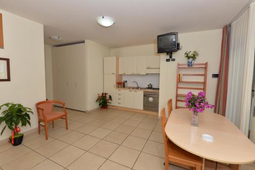 a kitchen and dining room with a table and chairs at Miramare Residence in Pozzuoli