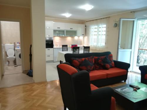 sala de estar con sofá rojo y cocina en Apartment Nikolic Kotor, en Kotor