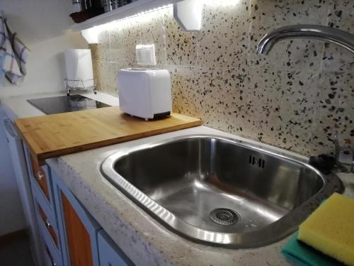 a kitchen sink with a soap dispenser on a counter at Casa Agata in Rhodes Town