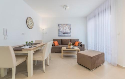 a living room with a couch and a table at Apartments Hana in Funtana in Funtana