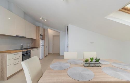 a kitchen and dining room with a table and chairs at Apartments Hana in Funtana in Funtana