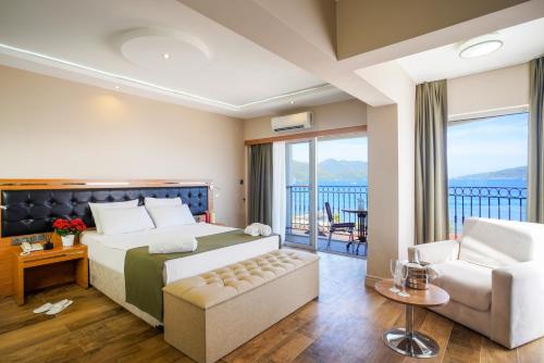 a hotel room with a bed and a balcony at Aurasia Sea Side Hotel in Marmaris