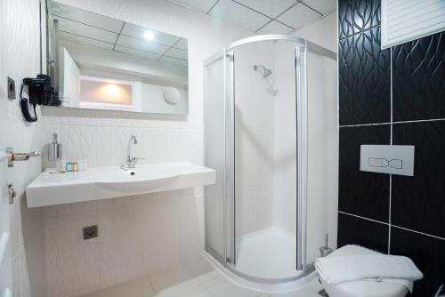 a bathroom with a shower and a sink and a toilet at Aurasia Sea Side Hotel in Marmaris
