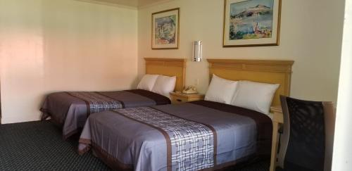 a hotel room with two beds in a room at Budget Lodge in Newport News