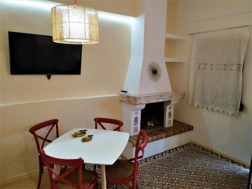 a dining room with a table and a fireplace at Luxury studio in the centre of Palaikastro in Palekastron