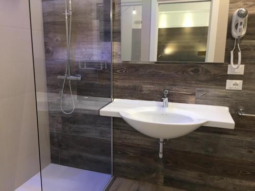 a bathroom with a sink and a shower at Dune Prestige & Chalets in Bibione