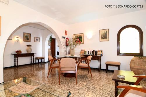 sala de estar con mesa y sillas en Hostal La Ceiba, en Cala d´Or