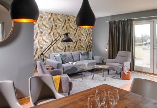 a living room with a couch and chairs and a table at Seafield Hotel & Spa Resort in Gorey