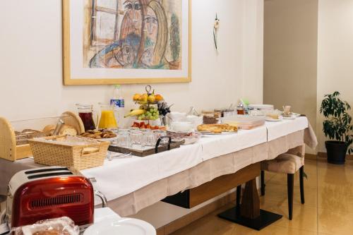a table with food on it with a white table cloth at Lido Hotel in Katerini