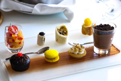 a tray with desserts and drinks on a table at Pullman Abidjan in Abidjan